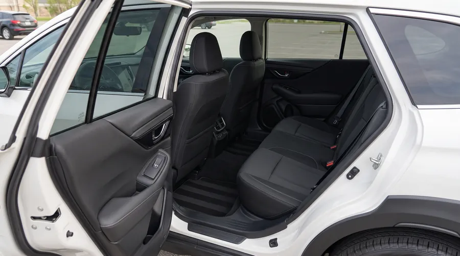 Clean black interior of a Subaru Outback with fresh vacuum lines
