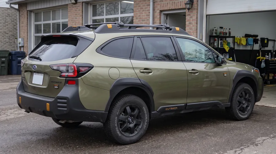 Green Subaru Outback with freshly tinted rear windows and clear front windows